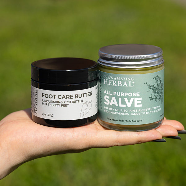 A hand holding two jars of Ora&