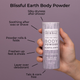 Hand holding of Blissful Earth Body Powder with benefits infographic highlighting its uses on a purple background.