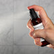 Blissful Earth Room Spray 2oz Lifestyle with Human Hand Spraying Square Microbatch Label
