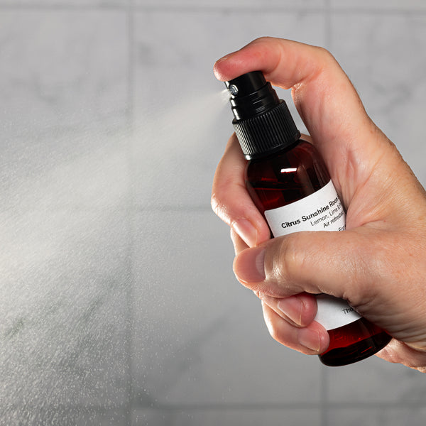 Citrus Sunshine Room Spray 2oz Lifestyle with Human Hand Spraying Square Microbatch Label