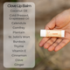 Hand holding a Clove lip balm with a list of ingredients on the left.