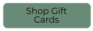 A muted green rounded rectangular button with the text 'Shop Gift Cards' in black sans-serif font.