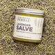 Lavender Salve 4oz Lifestyle Indoor on Top of Herbs