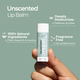 Unscented lip balm held in a hand with product details on a green background